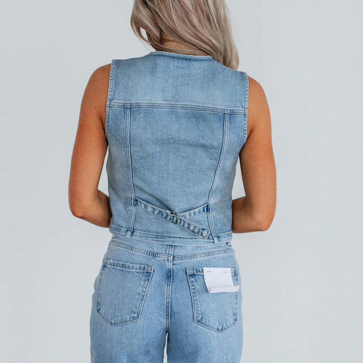 Women's denim vest with button placket and modern cut details. 4